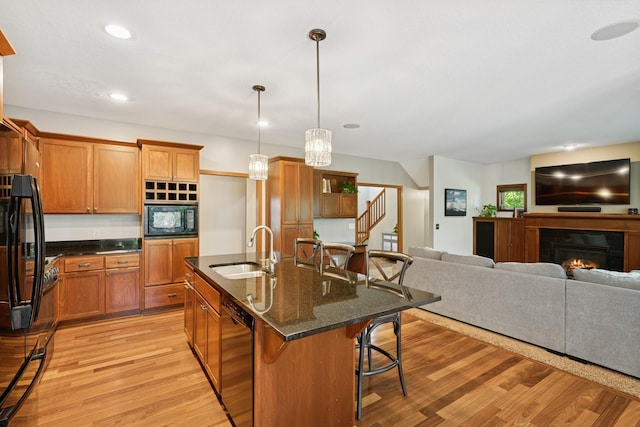 1020 Bliss Ln, Bloomington, MN 55431 - kitchen featuring black appliances, light wood-style floors, brown cabinetry, and recessed lighting