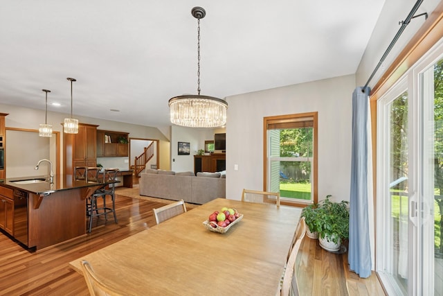 1020 Bliss Ln, Bloomington, MN 55431 - dining room with light wood-type flooring, stairway, and a chandelier