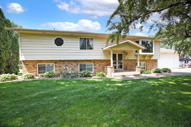 930 Minekahda Pl, Owatonna, MN 55060 - bi-level home with brick siding, a front lawn, french doors, an attached garage, and driveway