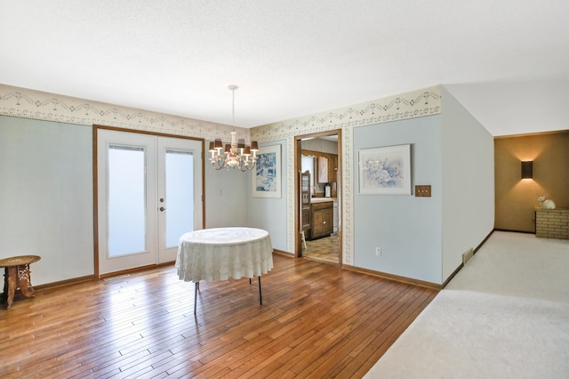 930 Minekahda Pl, Owatonna, MN 55060 - dining space featuring a chandelier, hardwood / wood-style flooring, and wallpapered walls