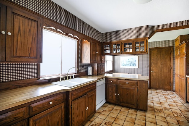 930 Minekahda Pl, Owatonna, MN 55060 - kitchen featuring white dishwasher, decorative backsplash, glass insert cabinets, a peninsula, and light countertops