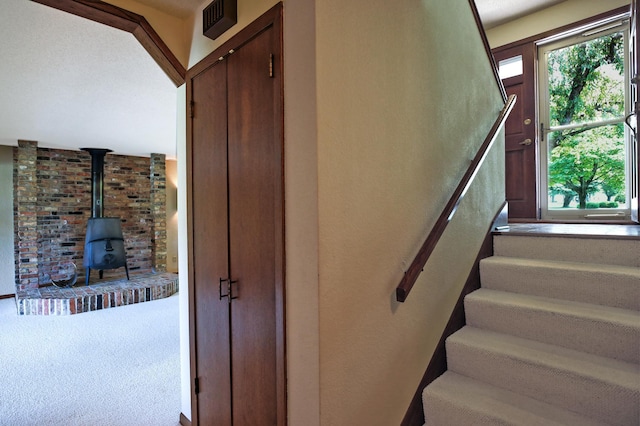 930 Minekahda Pl, Owatonna, MN 55060 - stairway with a wood stove and carpet