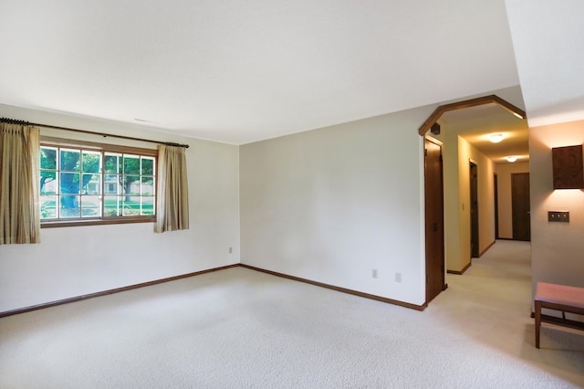 930 Minekahda Pl, Owatonna, MN 55060 - empty room featuring light colored carpet and arched walkways