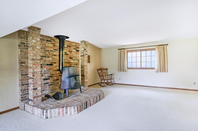 930 Minekahda Pl, Owatonna, MN 55060 - sitting room with a wood stove and carpet flooring