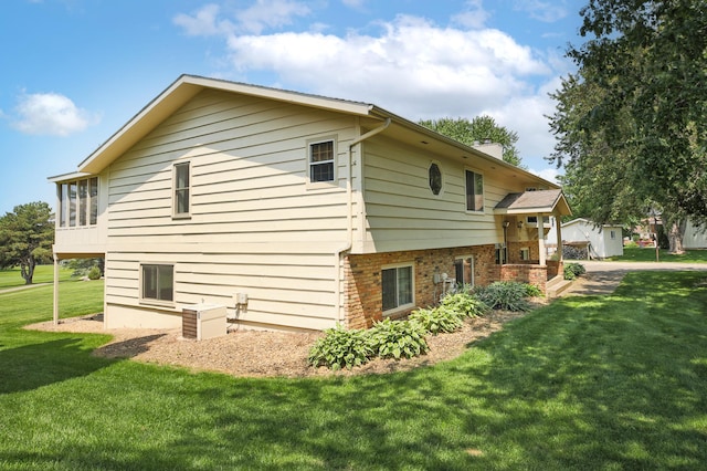 930 Minekahda Pl, Owatonna, MN 55060 - view of property exterior with a lawn, a chimney, and brick siding