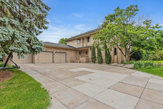 3817 Dunbar Ct N, Brooklyn Park, MN 55443 - view of front facade with driveway, an attached garage, and brick siding