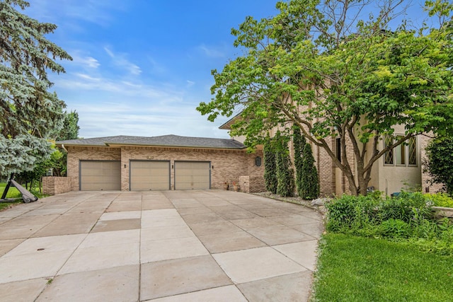 3817 Dunbar Ct N, Brooklyn Park, MN 55443 - view of front of house with concrete driveway, brick siding, and a garage