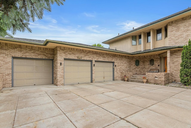 3817 Dunbar Ct N, Brooklyn Park, MN 55443 - view of front facade featuring driveway, brick siding, and an attached garage