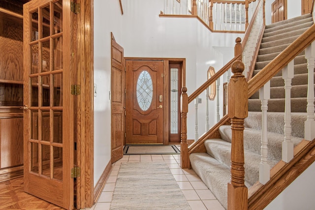 3817 Dunbar Ct N, Brooklyn Park, MN 55443 - entryway with a towering ceiling, stairway, and light tile patterned floors