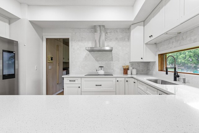 3817 Dunbar Ct N, Brooklyn Park, MN 55443 - kitchen with wall chimney range hood, light stone countertops, white cabinets, and black electric cooktop