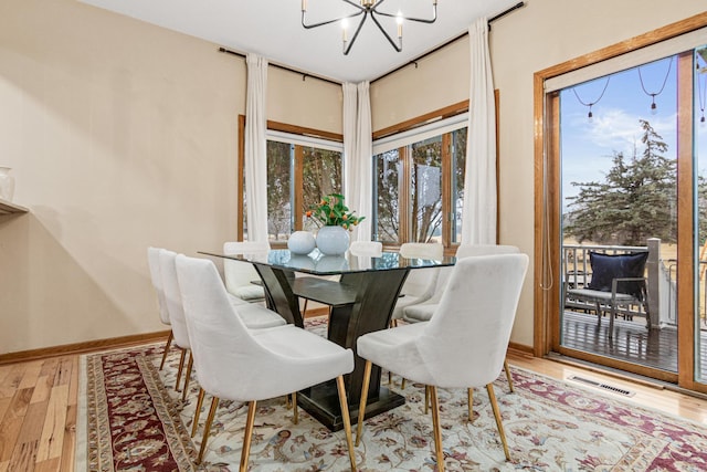 3817 Dunbar Ct N, Brooklyn Park, MN 55443 - dining room featuring a chandelier and wood finished floors
