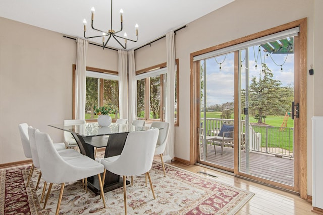 3817 Dunbar Ct N, Brooklyn Park, MN 55443 - dining room featuring a chandelier and light wood finished floors