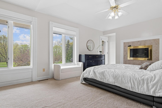 3817 Dunbar Ct N, Brooklyn Park, MN 55443 - carpeted bedroom with multiple windows and ceiling fan