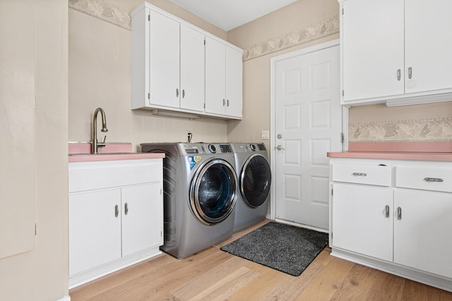 3817 Dunbar Ct N, Brooklyn Park, MN 55443 - laundry room with cabinet space, washer and clothes dryer, and light wood finished floors