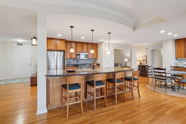 8301 Creekside Cir Unit 570, Bloomington, MN 55437 - kitchen featuring stainless steel appliances, light wood-type flooring, brown cabinetry, ornamental molding, and recessed lighting