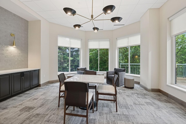 8301 Creekside Cir Unit 570, Bloomington, MN 55437 - dining space featuring healthy amount of natural light, light colored carpet, and a chandelier