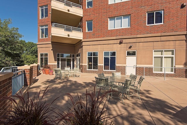8301 Creekside Cir Unit 570, Bloomington, MN 55437 - rear view of property with brick siding, outdoor dining area, and a patio area
