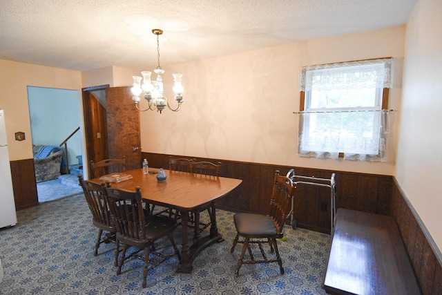 21840 320th Ave NW, Warren, MN 56762 - dining area featuring wainscoting, a chandelier, a textured ceiling, and stairs