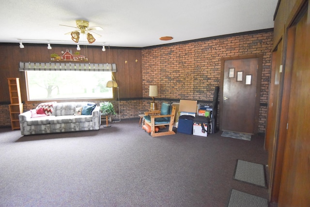 21840 320th Ave NW, Warren, MN 56762 - carpeted living room featuring brick wall, a ceiling fan, and rail lighting