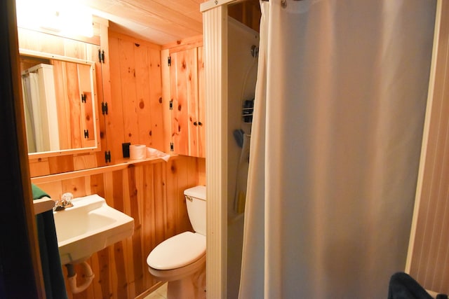 21840 320th Ave NW, Warren, MN 56762 - bathroom featuring wooden walls and a shower with shower curtain