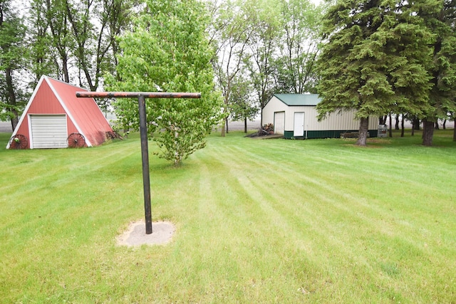 21840 320th Ave NW, Warren, MN 56762 - view of grassy yard with an outbuilding and a detached garage