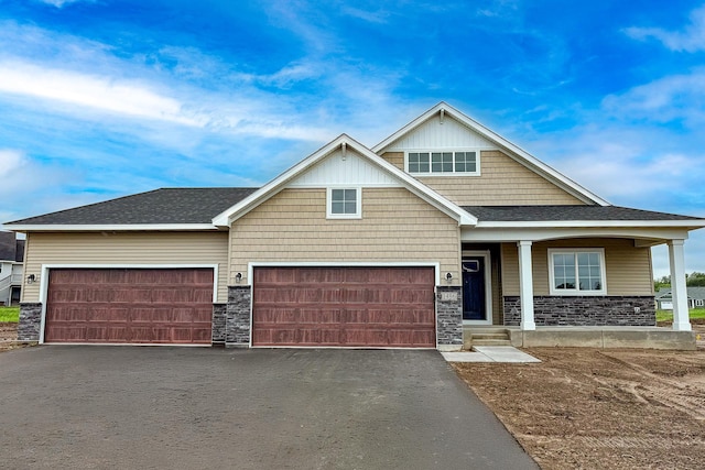 1486 Otter Way, New Richmond, WI 54017 - craftsman inspired home with driveway, stone siding, an attached garage, and covered porch