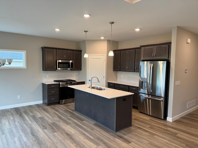1486 Otter Way, New Richmond, WI 54017 - kitchen with appliances with stainless steel finishes, wood finished floors, light countertops, dark brown cabinets, and recessed lighting