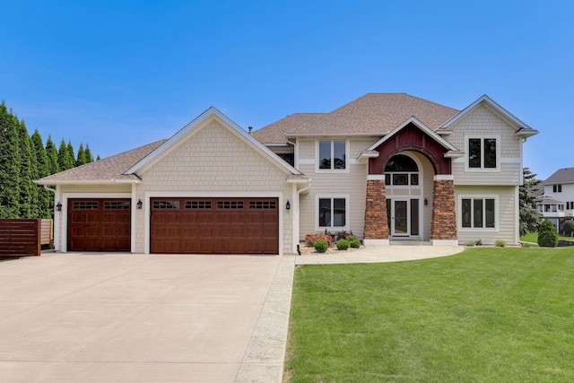 121 Wexford Heights Dr, New Brighton, MN 55112 - craftsman-style house with concrete driveway, an attached garage, a front yard, stone siding, and roof with shingles