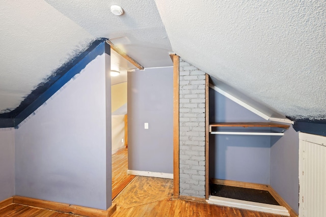 5545 45th Ave S, Minneapolis, MN 55417 - additional living space with a textured ceiling, vaulted ceiling, and wood finished floors