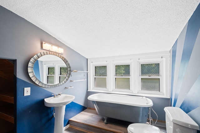 5545 45th Ave S, Minneapolis, MN 55417 - full bathroom with a textured ceiling, a freestanding bath, and wood finished floors
