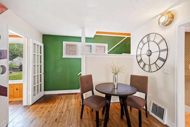5545 45th Ave S, Minneapolis, MN 55417 - dining room featuring hardwood / wood-style floors and a textured ceiling