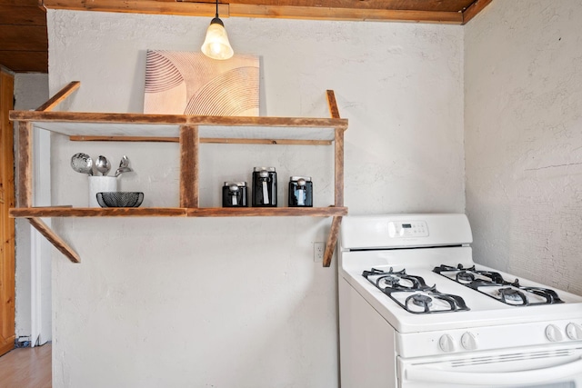5545 45th Ave S, Minneapolis, MN 55417 - kitchen with white gas range, light wood-style floors, pendant lighting, and a textured wall