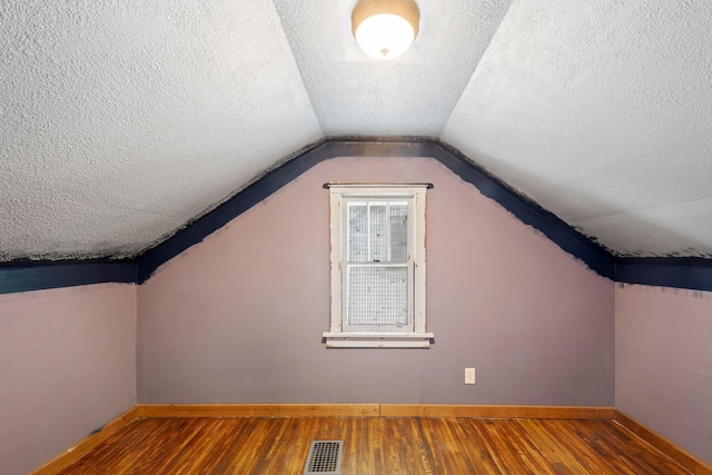 5545 45th Ave S, Minneapolis, MN 55417 - bonus room featuring a textured ceiling, wood finished floors, and vaulted ceiling