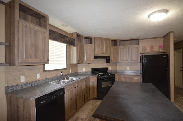 311 Mozart Ave E, Mankato, MN 56001 - kitchen with open shelves, black appliances, light wood-style flooring, under cabinet range hood, and decorative backsplash