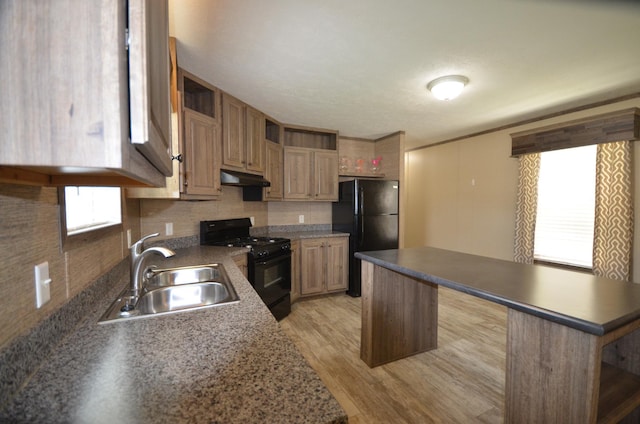 311 Mozart Ave E, Mankato, MN 56001 - kitchen featuring black appliances, under cabinet range hood, tasteful backsplash, light wood-style floors, and a center island