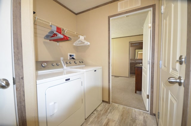 311 Mozart Ave E, Mankato, MN 56001 - laundry area with separate washer and dryer, light wood-style floors, and crown molding