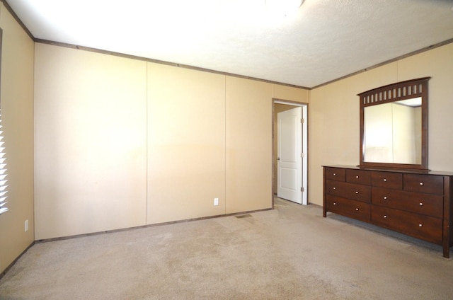 311 Mozart Ave E, Mankato, MN 56001 - unfurnished bedroom featuring light carpet and crown molding