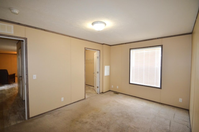 311 Mozart Ave E, Mankato, MN 56001 - unfurnished bedroom with ornamental molding and carpet floors