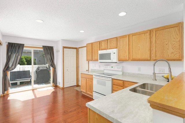 5055 149th St N Unit 2, Hugo, MN 55038 - kitchen with white appliances, a textured ceiling, light countertops, wood finished floors, and recessed lighting