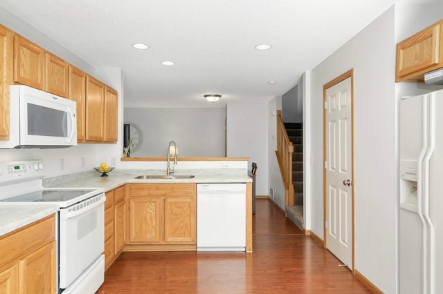5055 149th St N Unit 2, Hugo, MN 55038 - kitchen with white appliances, dark wood-style flooring, recessed lighting, light countertops, and a peninsula