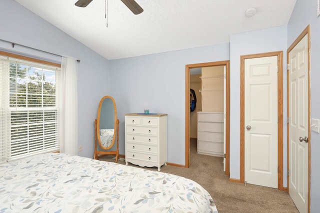 5055 149th St N Unit 2, Hugo, MN 55038 - carpeted bedroom with a spacious closet, vaulted ceiling, a ceiling fan, and a textured ceiling