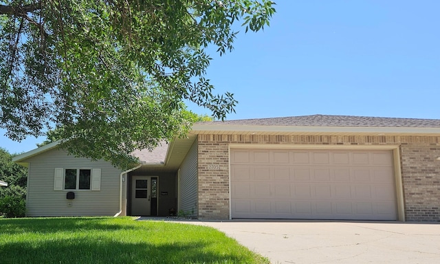 2705 9th St SW, Willmar, MN 56201 - ranch-style home with brick siding, a garage, driveway, and a front lawn