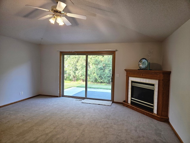 2705 9th St SW, Willmar, MN 56201 - unfurnished living room featuring carpet flooring, a tiled fireplace, ceiling fan, and a textured ceiling