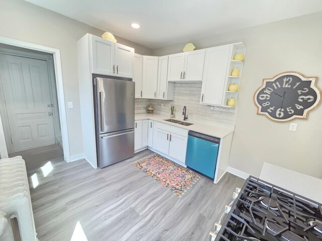 1323 Lincoln Ave, Saint Paul, MN 55105 - kitchen with freestanding refrigerator, dishwashing machine, a sink, light countertops, and light wood-style flooring