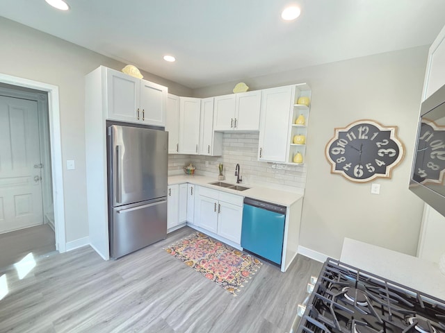 1323 Lincoln Ave, Saint Paul, MN 55105 - kitchen with freestanding refrigerator, dishwasher, a sink, light wood finished floors, and light countertops