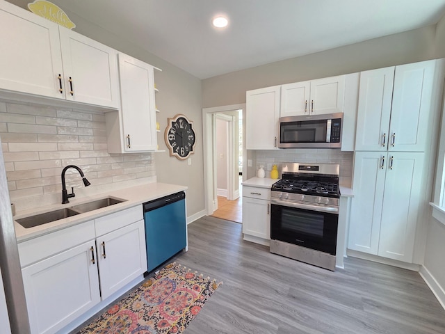 1323 Lincoln Ave, Saint Paul, MN 55105 - kitchen with stainless steel appliances, a sink, backsplash, light countertops, and recessed lighting