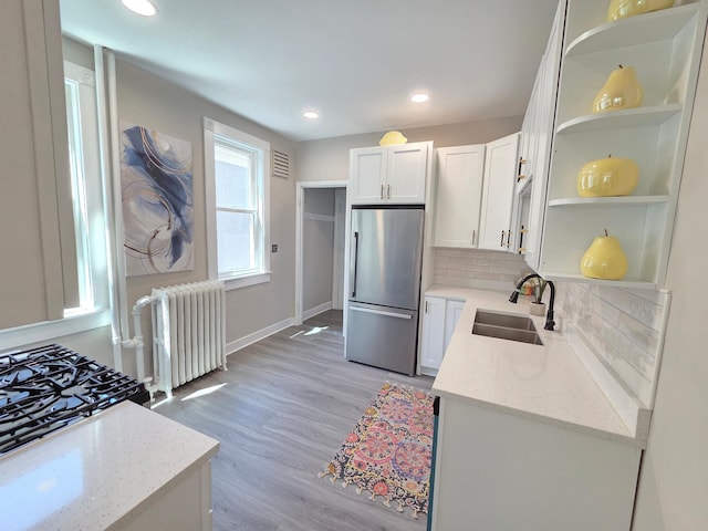 1323 Lincoln Ave, Saint Paul, MN 55105 - kitchen with stainless steel refrigerator, open shelves, radiator heating unit, a sink, and white cabinetry