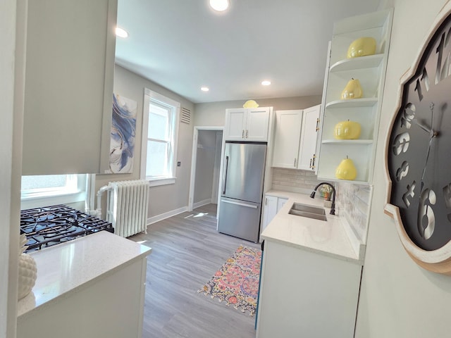 1323 Lincoln Ave, Saint Paul, MN 55105 - kitchen with freestanding refrigerator, radiator, a sink, open shelves, and baseboards