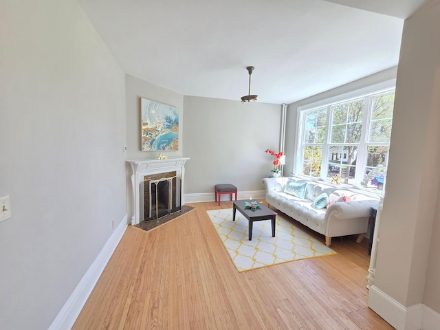 1323 Lincoln Ave, Saint Paul, MN 55105 - living area with light wood-type flooring, baseboards, and a fireplace