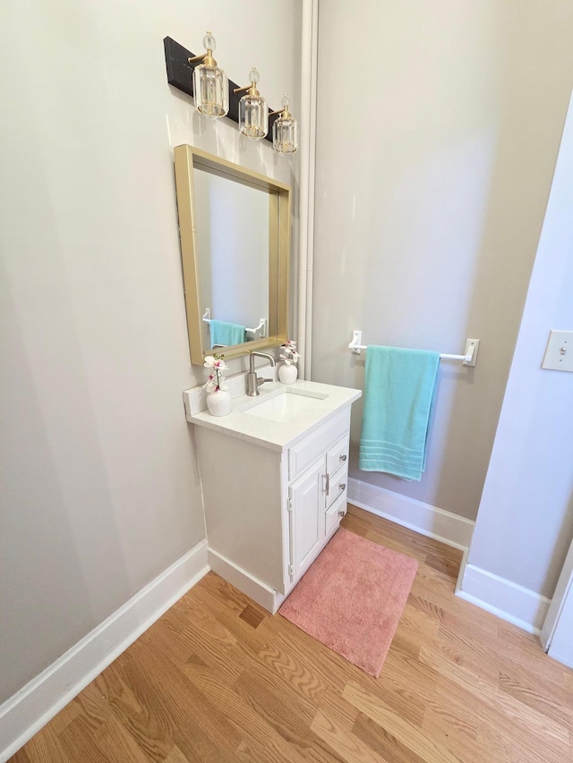 1323 Lincoln Ave, Saint Paul, MN 55105 - bathroom with wood finished floors, vanity, and baseboards
